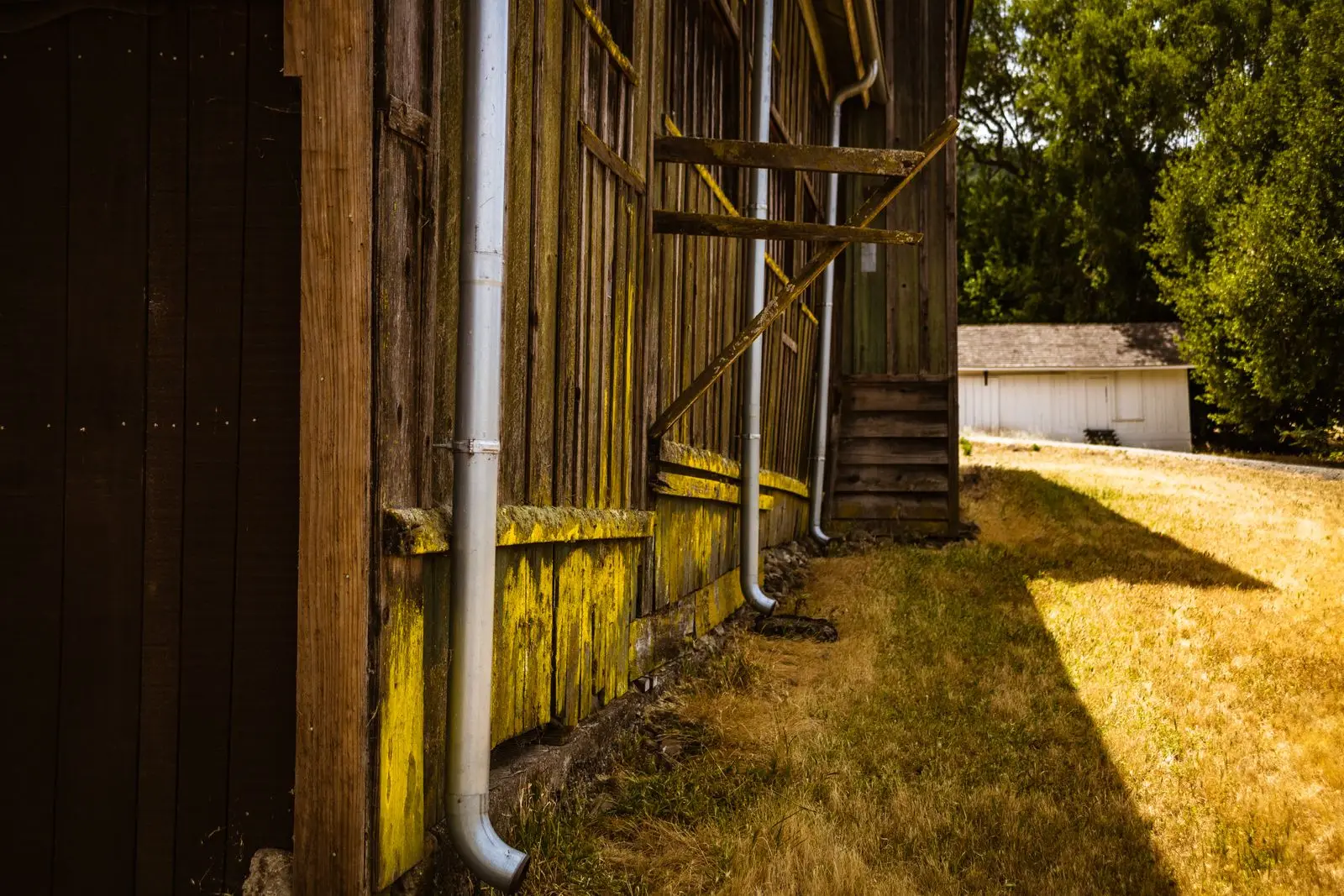 Gutter downspout on the side of a wooden building